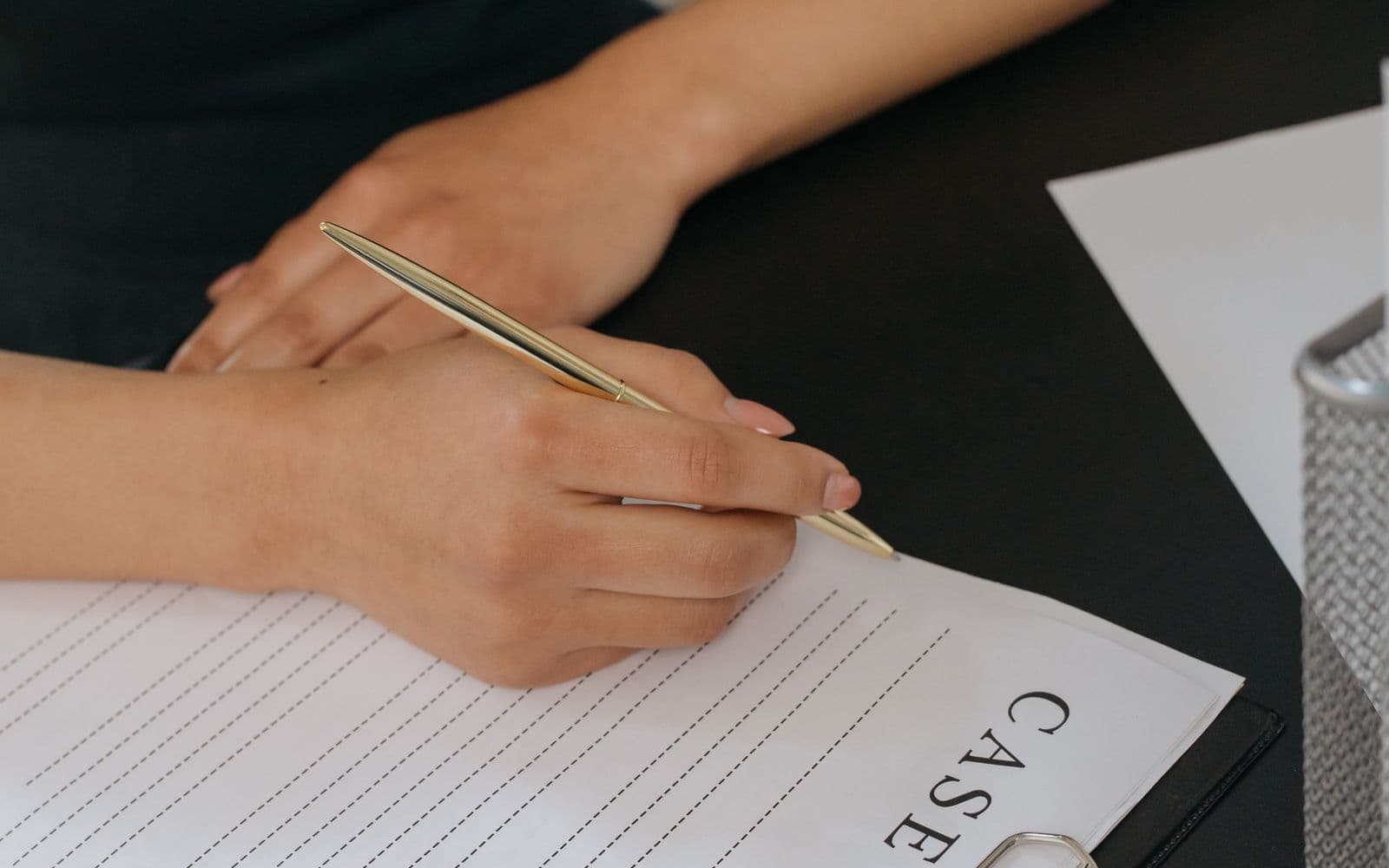Hand reviewing a case document with a pen