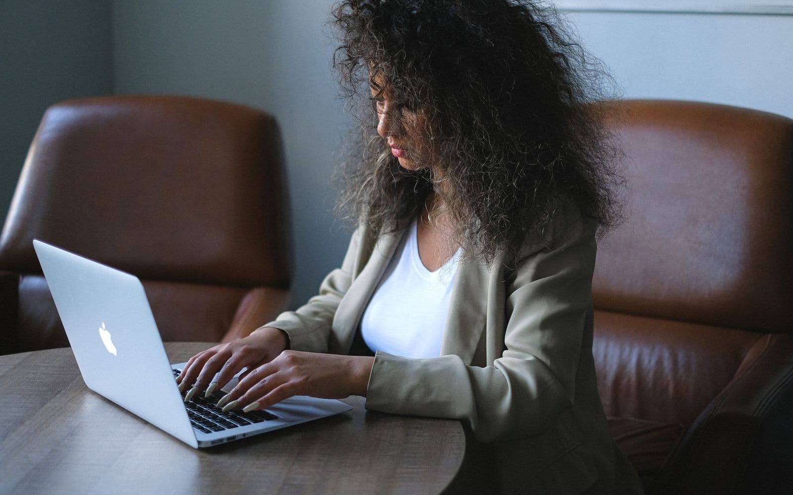 Professional working at a laptop in a bright office
