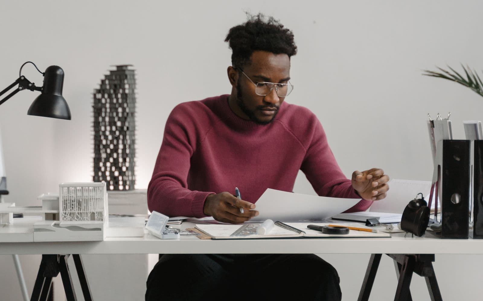 Man checking documents beside an organised desk